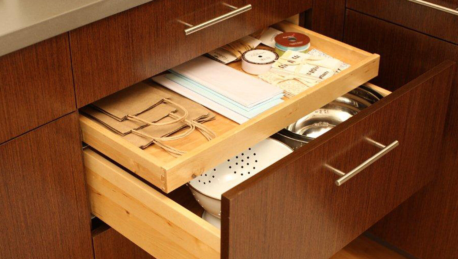 A Shallow Roll-Out Above Drawer is a great way to store miscellaneous school supplies and lunch bags.