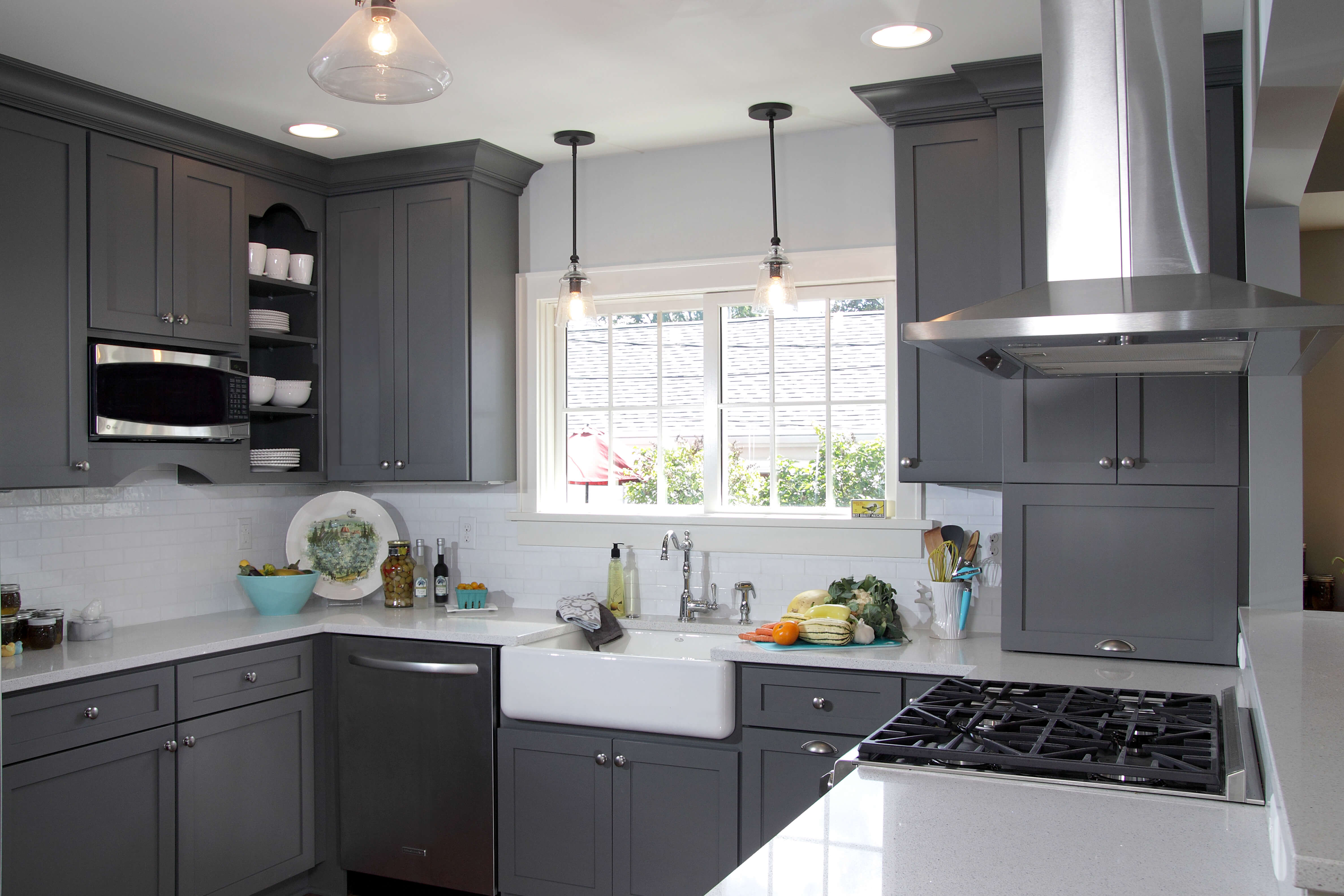 A dark gray and white kitchen with storm gray painted kitchne cabinets from Dura Supreme Cabinetry.