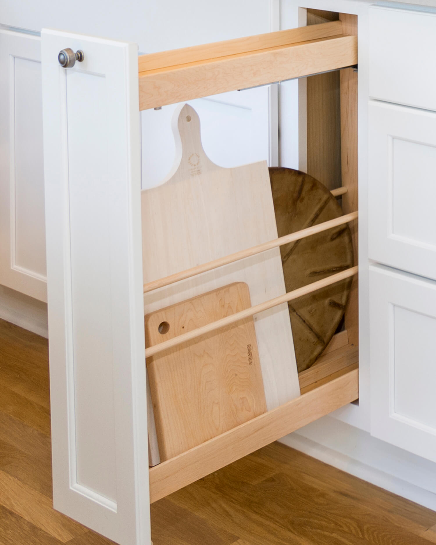 A Pull-Out Tray Cabinet from Dura Supreme offers practical and convenient use of space and works great for storing cutting boards in small spaces.