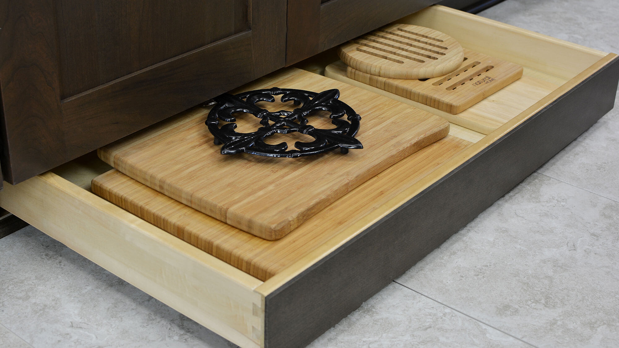 Dura Supreme Toe Space Drawer hidden at the foot of your cabinets is great for storing your cutting boards, trivets, rolling pins, and much more!
