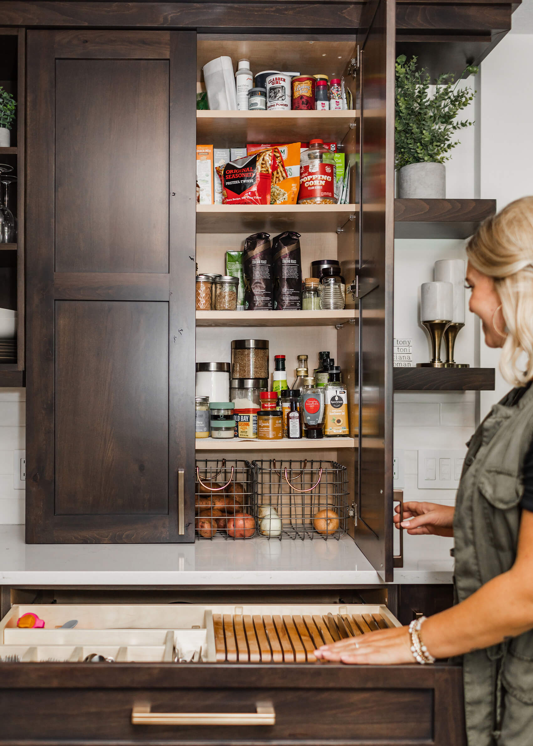 A larder cabinet with Pantry supplies at counter height.