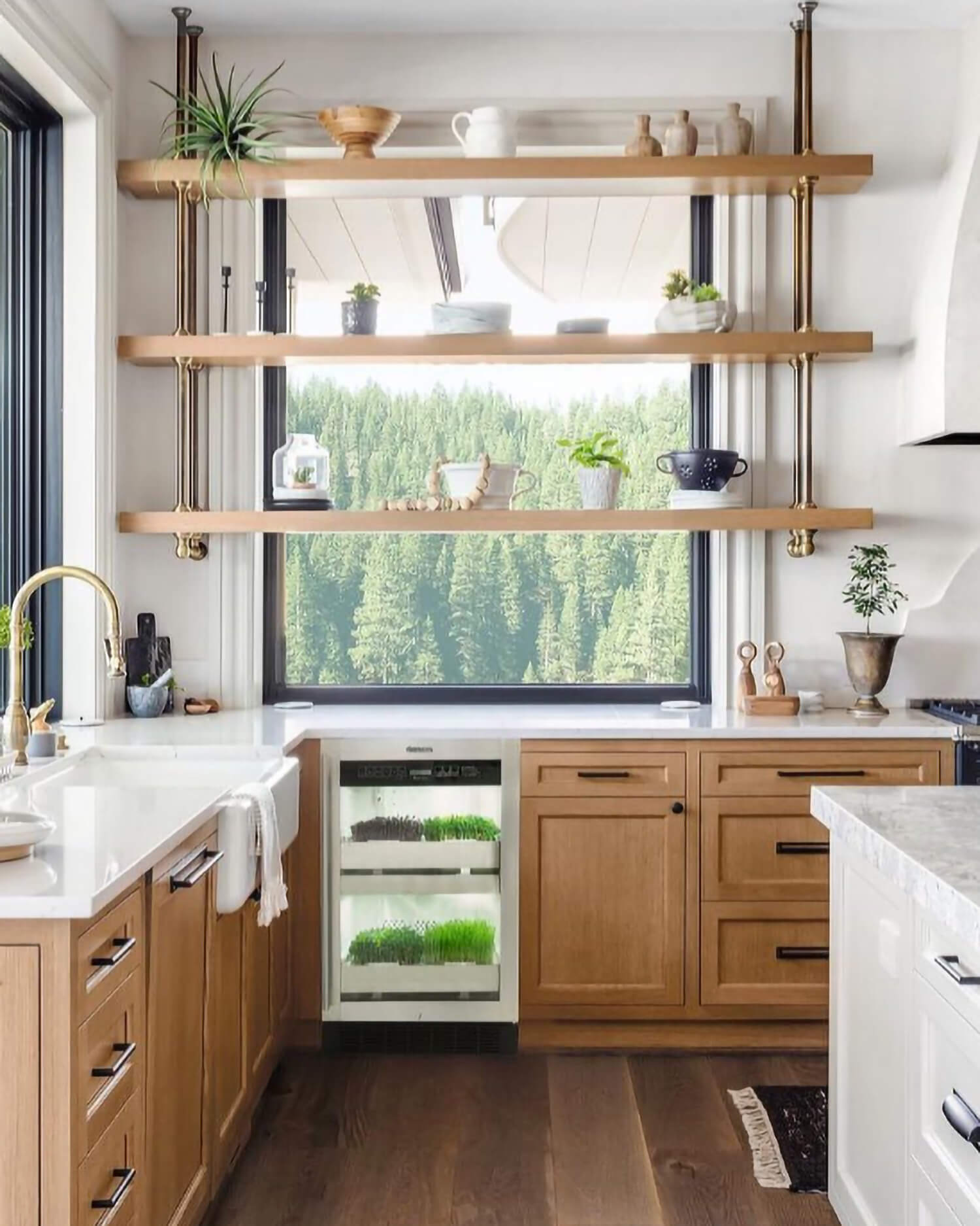 Custom kitchen cabinets with an integrated Urban Cultivator Residential system bring fresh herbs and vegetables into the heart of the kitchen. Open shelving, light stained wood cabinetry, and a thoughtfully planned prep zone support everyday cooking and entertaining.