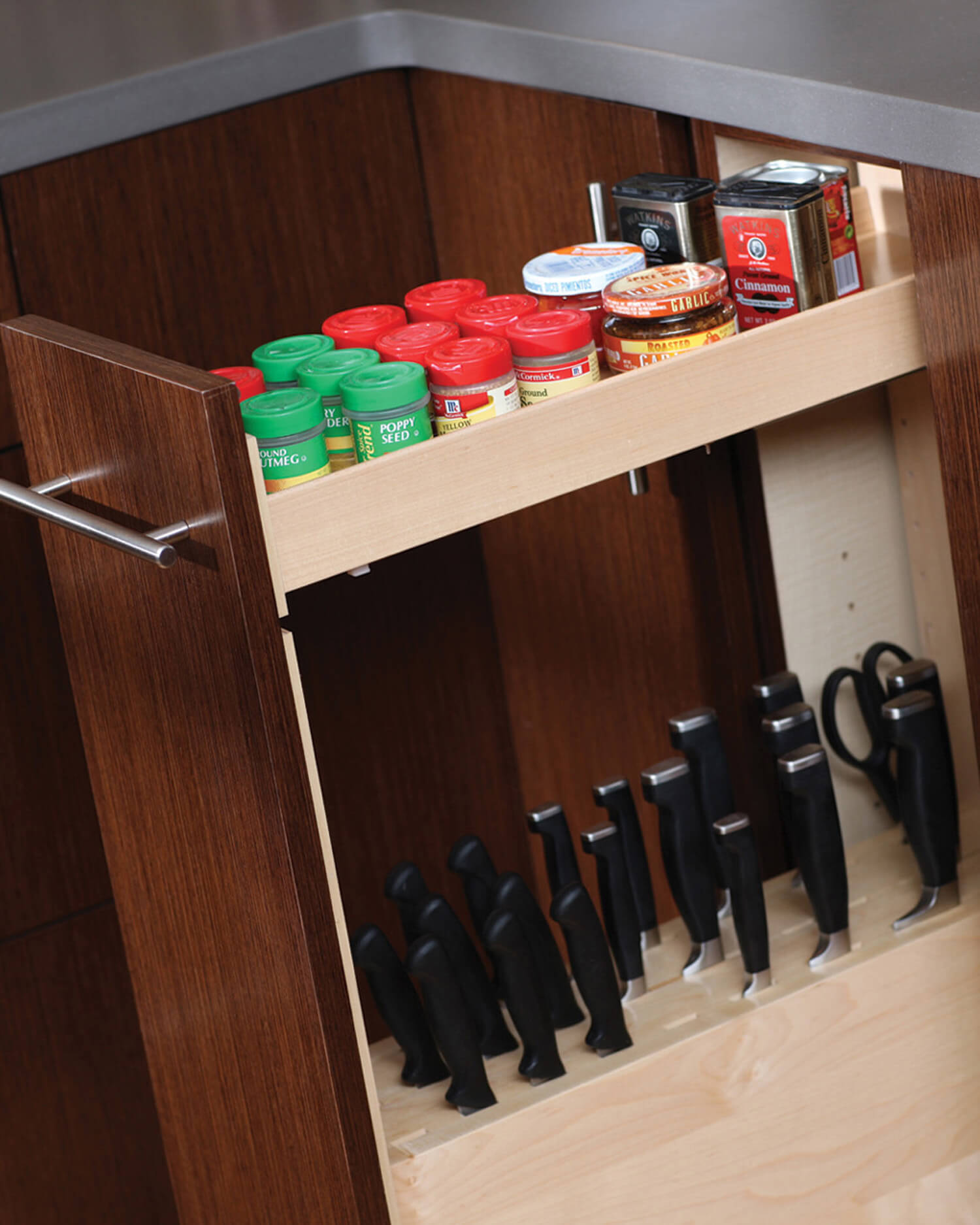 A pull-out cabinet with hidden knife block storage. The top shelf of Dura Supreme's pull-out accessories includes a multi-purposeful tray at the top.