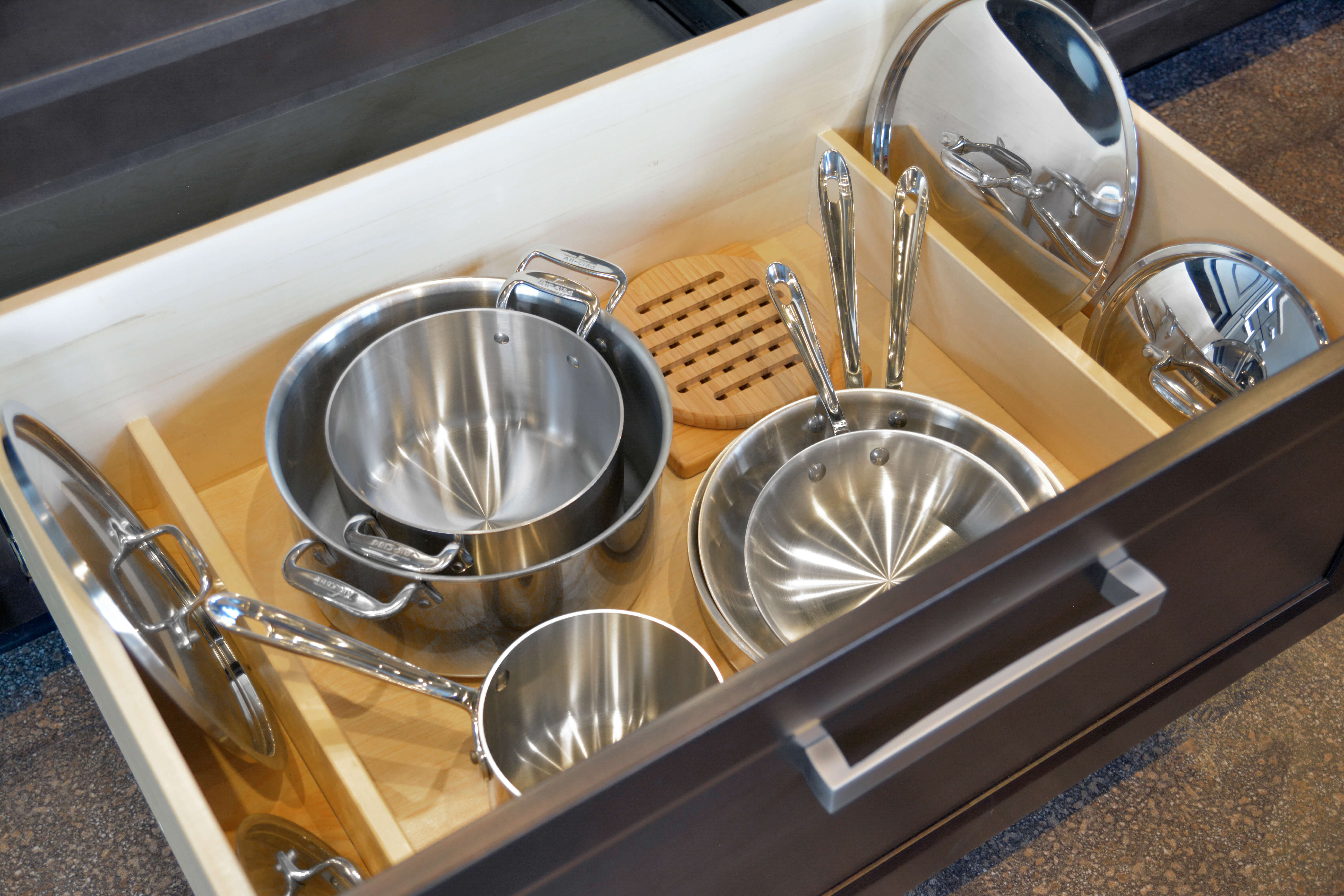 A deep drawer below a cooktop is an ideal location for pots and pans. Add Dura Supreme's Lid Storage Partitions (LSP-S) to stand lids on both sides of the drawer for easier access.