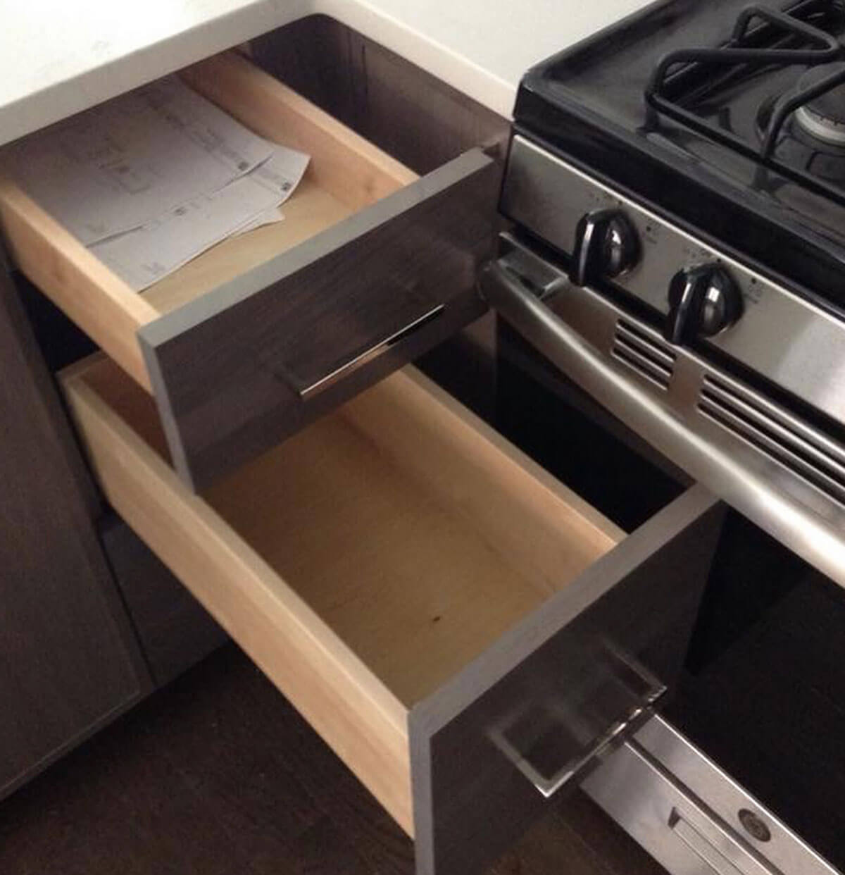 A kitchen drawer bumping into the appliance handle of an oven.