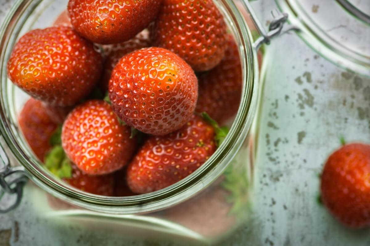 A close up of fresh picked strawberries for canning jams. A kitchen remodel designed for canned goods.
