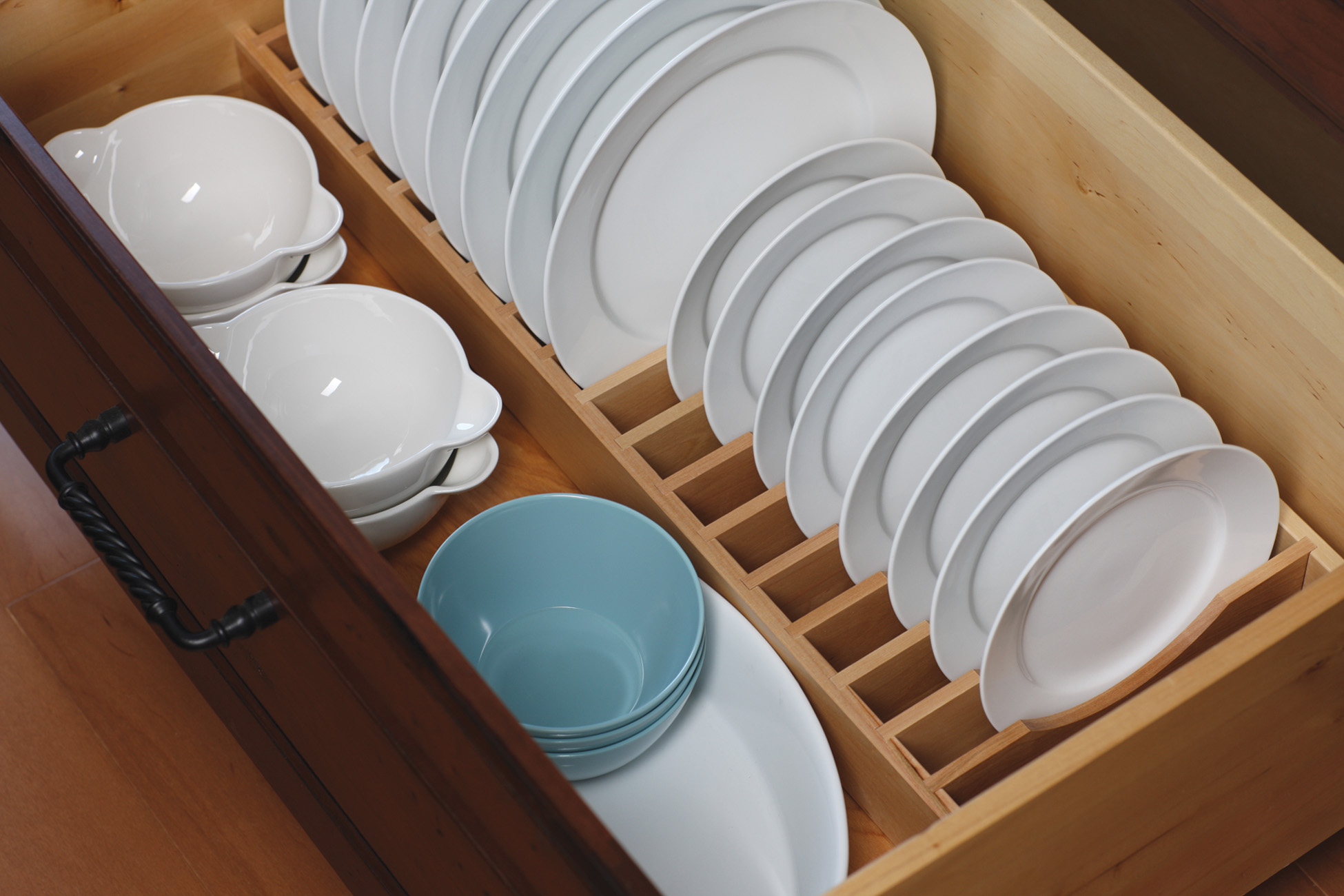 A Plate Rack Drawer from Dura Supreme creates a convenient location and a unique way to store an entire set of dishware within easy reach.