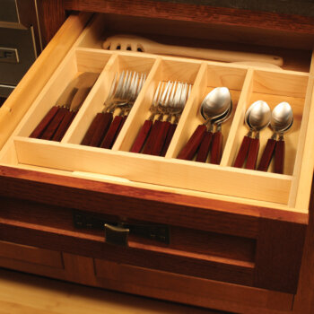 A kitchen drawer with a cutlery divider tray from Dura Supreme Cabinetry.