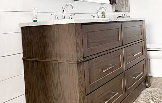 A close up of a gray stained bathroom vanity from Dura Supreme Cabinetry.