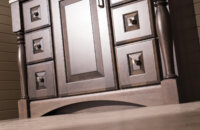 A close up of a traditional styled vanity with an elegant decorative toe kick.