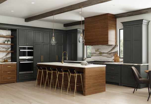 Dark gray-green and rich stained wood kitchen with modern farmhouse style, shiplap wood hood, shiplap kitchen island end cap, and brassy hardware and fixtures. Features floor-to-ceiling dark gray painted cabinets.