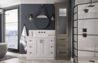 A wintery gray and white master a white painted oak vanity and a tall linen cabinet with a leaded glass mirror door.