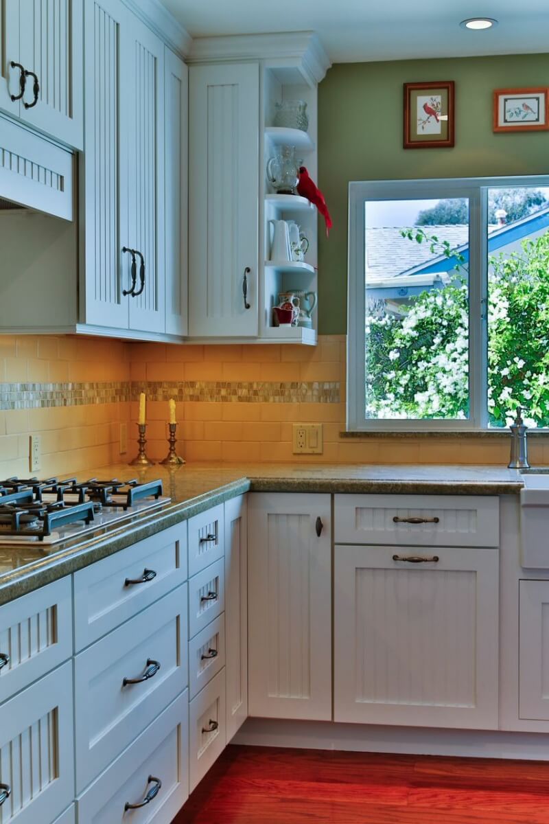 A cottage styled kitchen with a corner wall cabinet and a corner base cabinet with Dura Supreme Cabinetry.