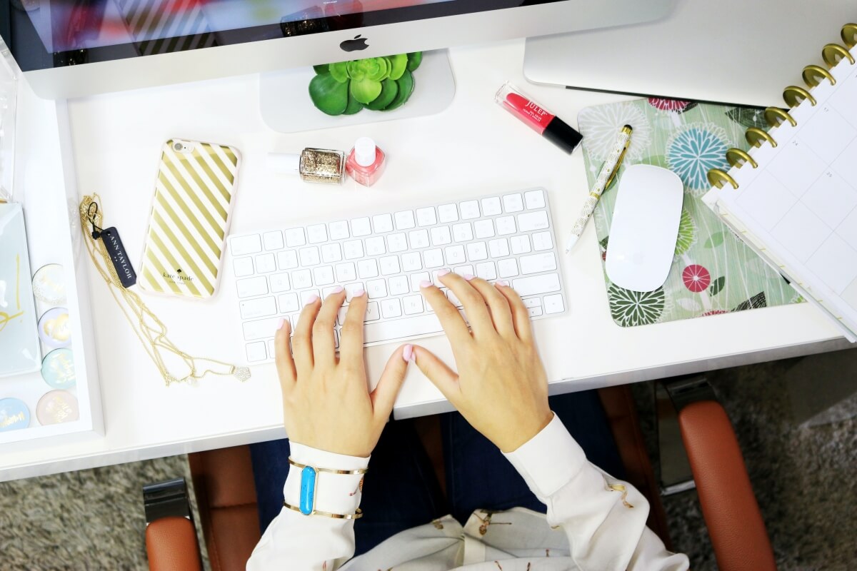 A close up of someone working from home doing their work remotley in their beautiful home office.