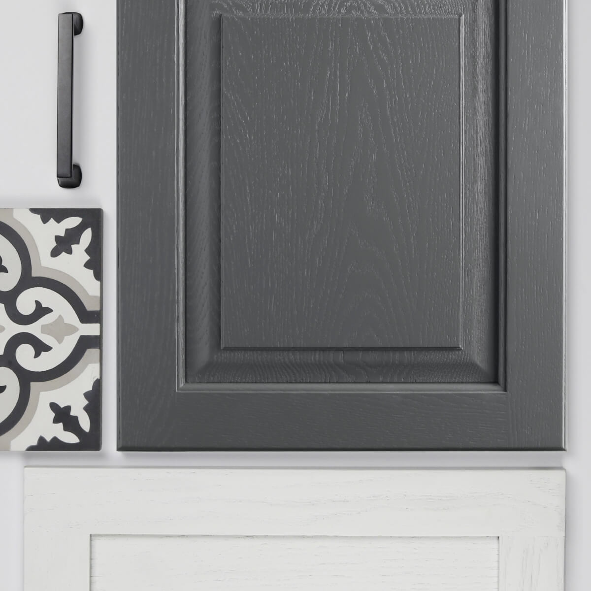 A close up of two cabinet doors with a painted oak finish showing the texture of the wood grain through the sleek layer of paint.