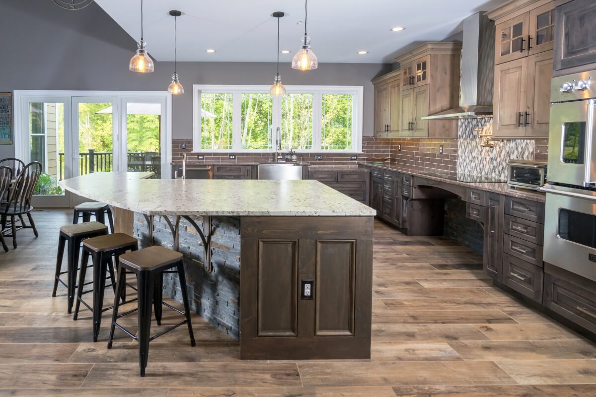 A rustic kitchen design with wheel chair accessible kitchen island, kitchen sink, cooktop, and additional accessible work zones.
