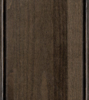 This finish color for rustic Knotty Alder cabinets is shown in the Feather stained finish by Dura Supreme Cabinetry. A medium to dark cabinet color with a neutral brown-gray undertone.