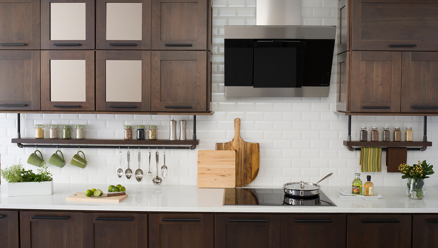 This industrial styled kitchen showcases Dura Supreme’s Craftsman Panel door style in the dark, true-brown Poppy Seed stain on Cherry with accented Bronze Mirror inserts.