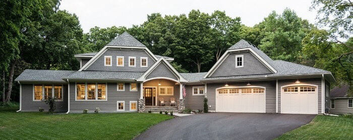 The exterior of a brand new custom home with a modern farmhouse style.