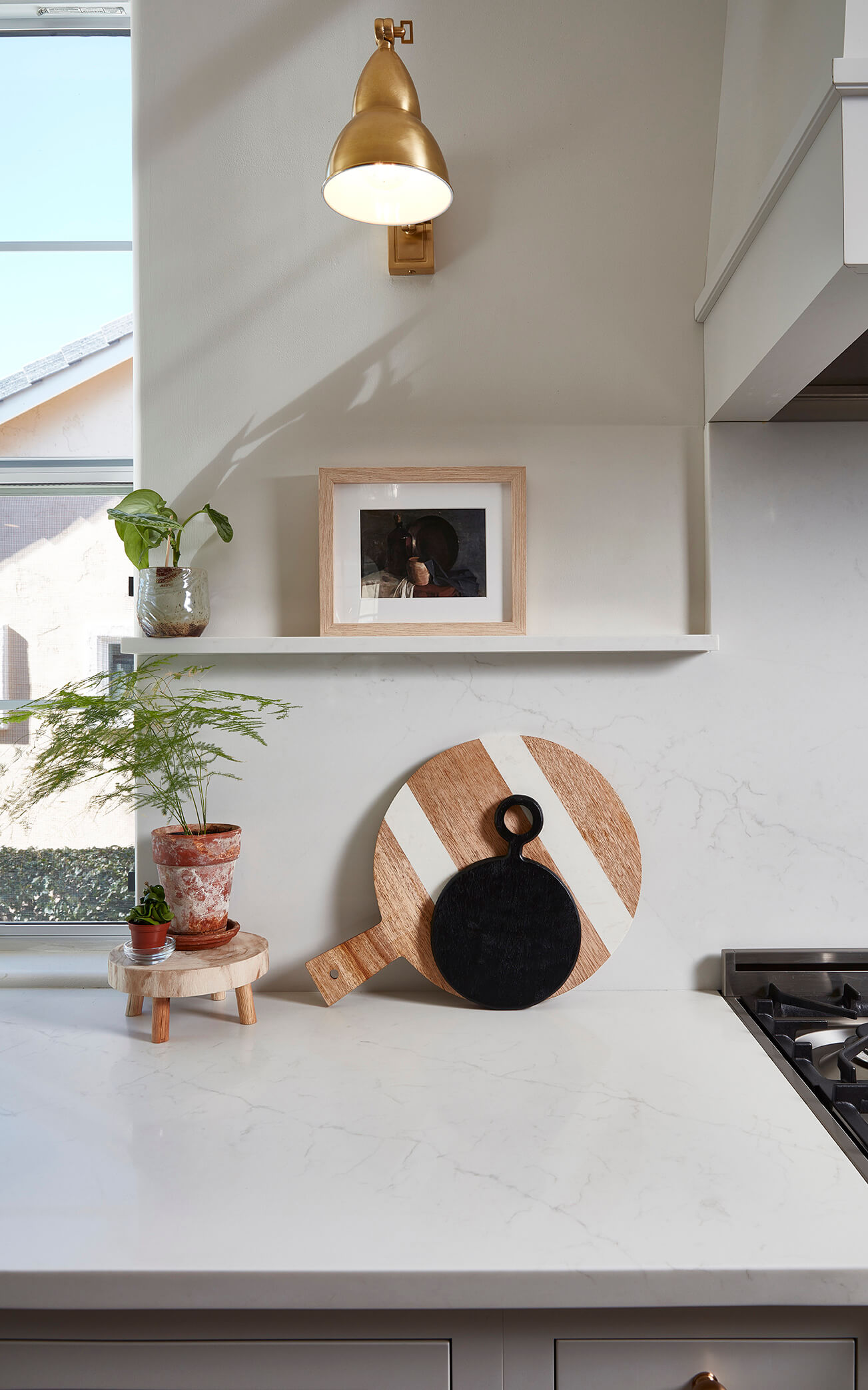 A solid quartz backsplash with a small ledge shelf for displaying decor.