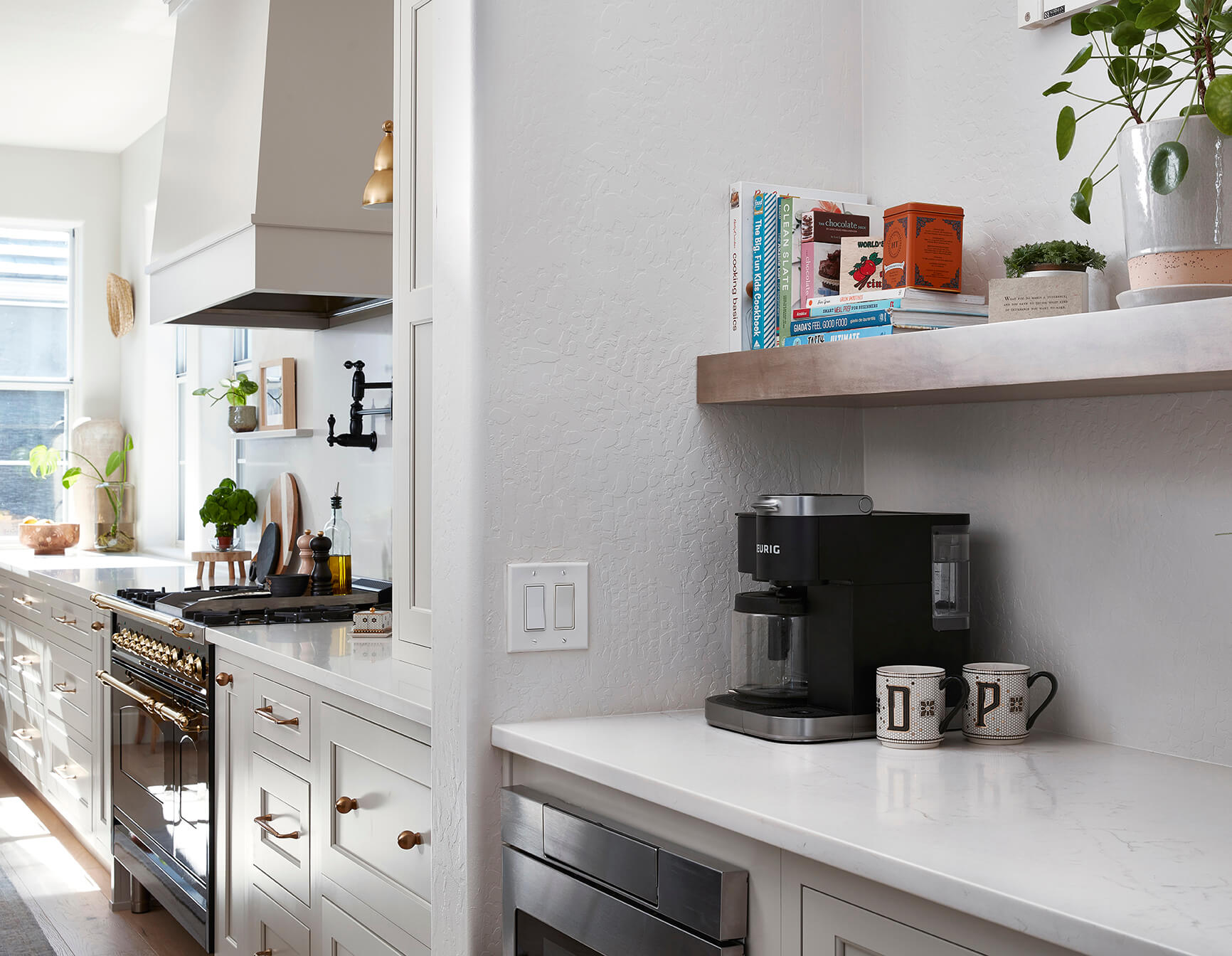 The open butler's pantry in this modern farmhouse kitchen remodel has a beautiful wood floating shelf and space for a coffee bar.