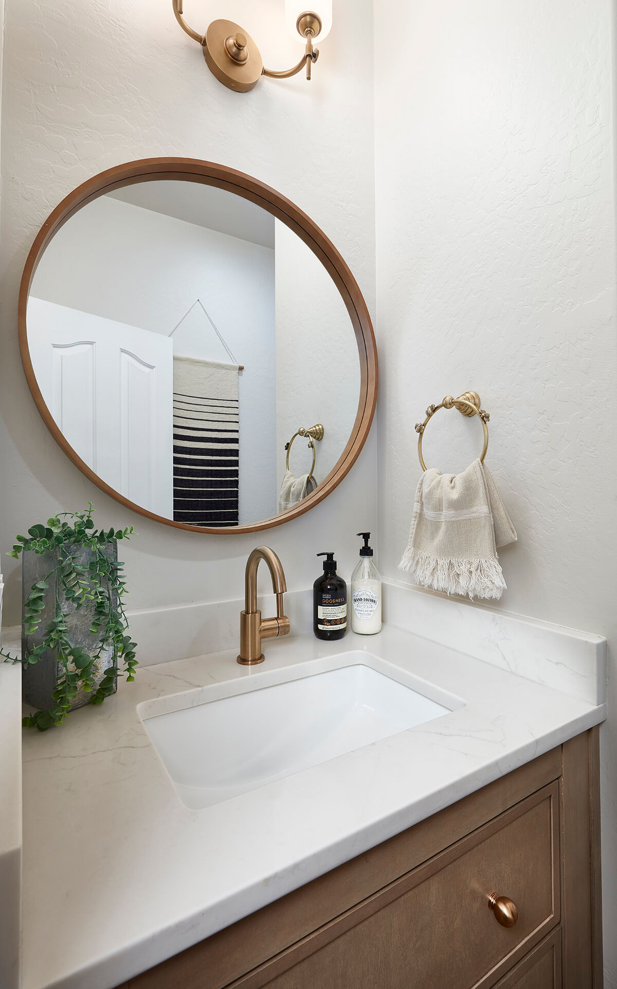 A beuatiful powder room with a maple furniture vanity.