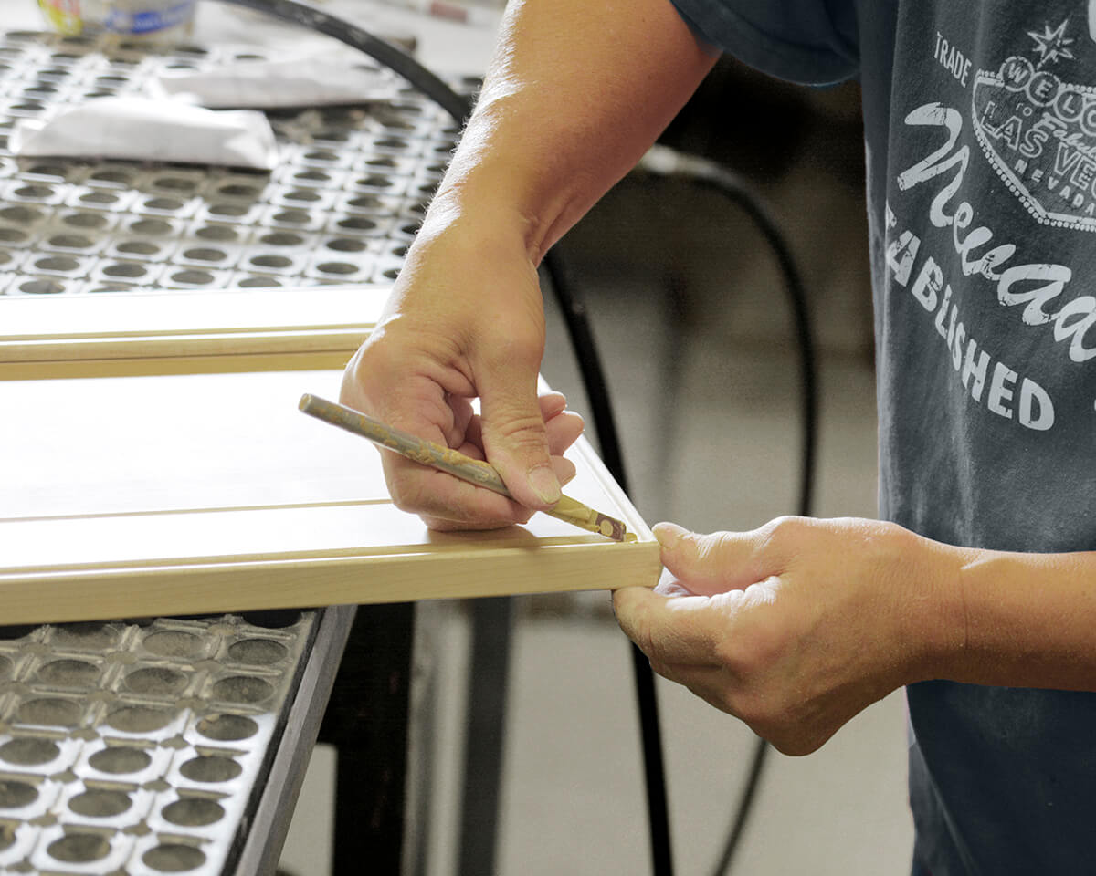 Dura Supreme cabinet maker preparing a cabinet door before it's finished.