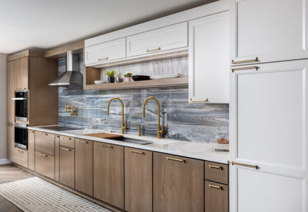 A two-toned one-wall kitchen with white and medium stained cabinets from Dura Supreme.