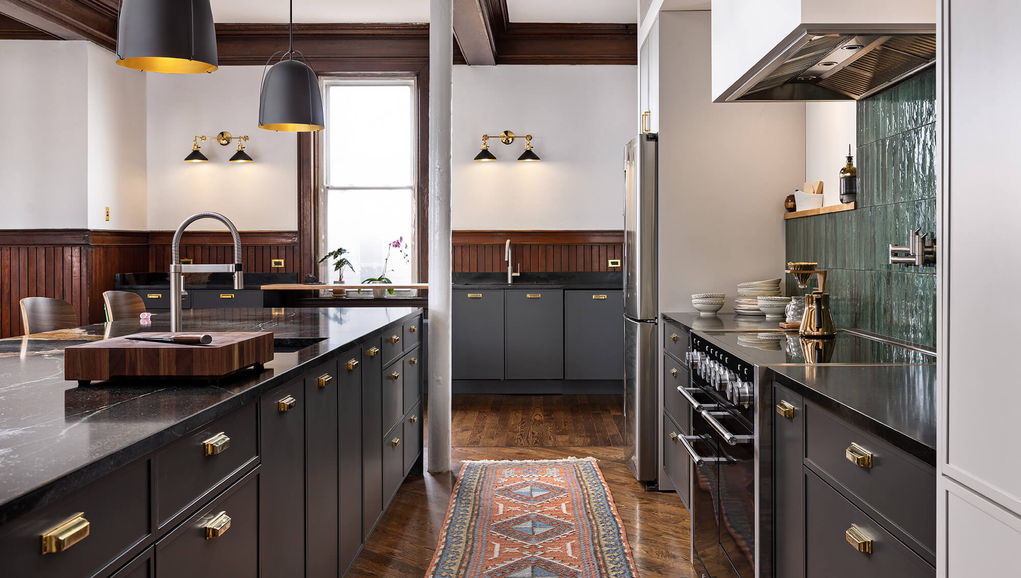 An urban remodel with charcoal gray cabinets with sleek modern shaker cabinets doors with a frameless construction.