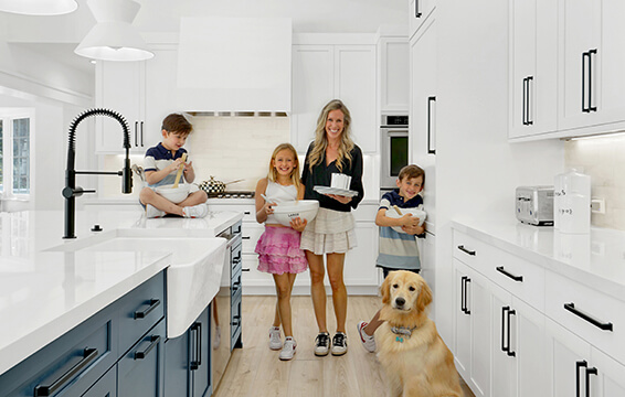 A happy family of 5 enjoys their bright and beautiful Dura Supreme kitchen.