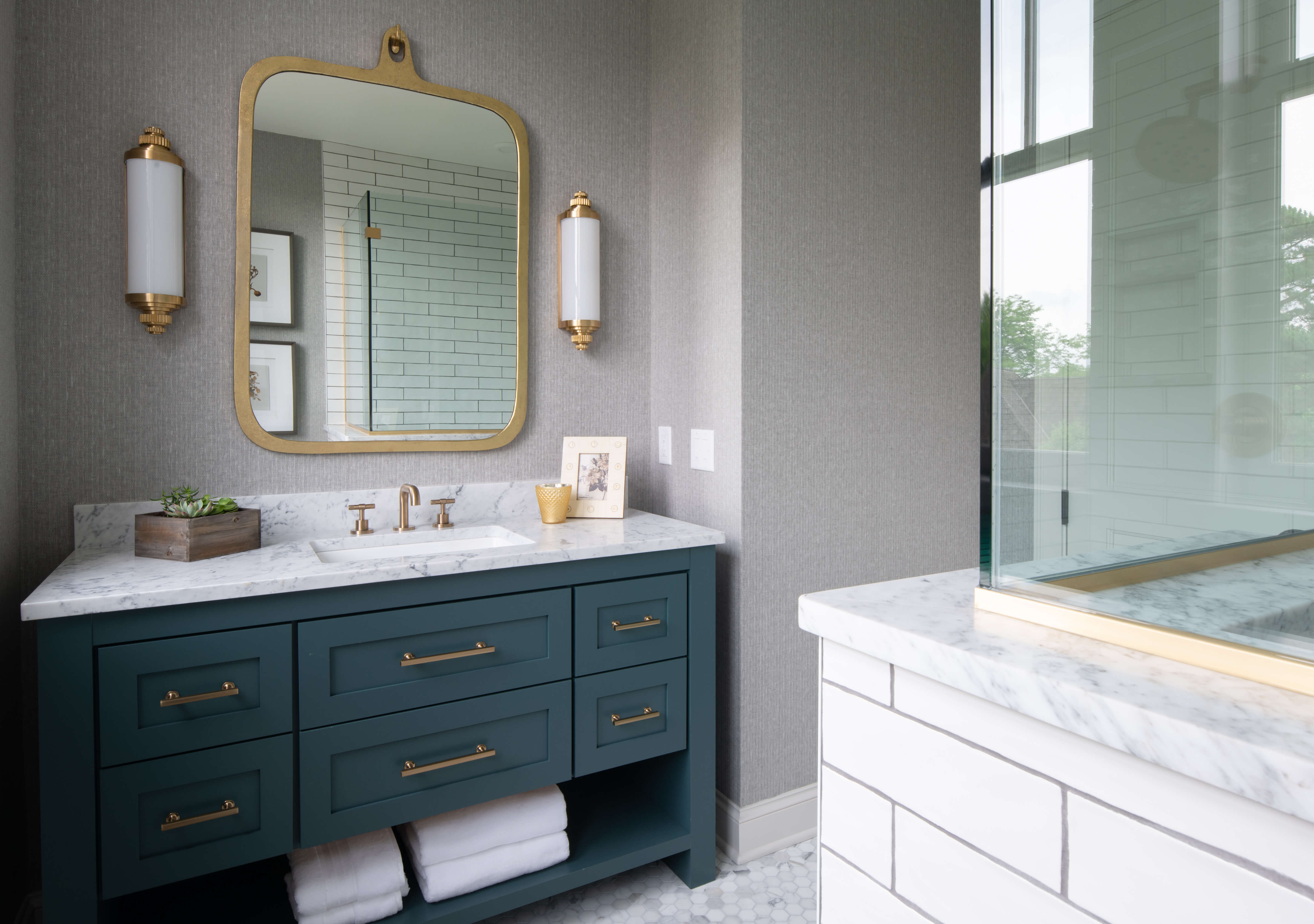 An ocean blue vanity with a furniture style look in a modern farmhouse.