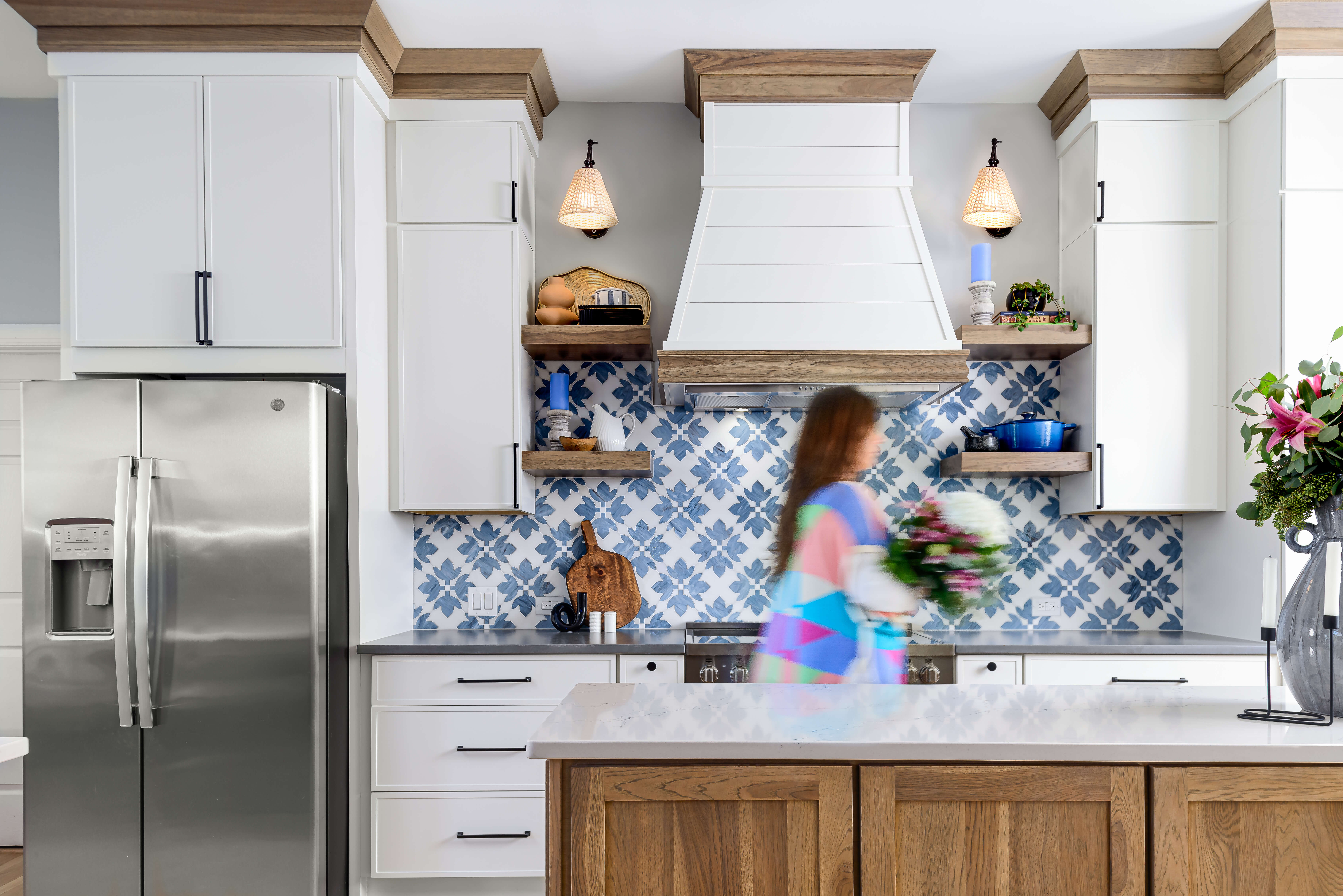 A bright and colorful Modern Farmhouse style kitchen design with an independent shiplap wood hood and floating shelves.