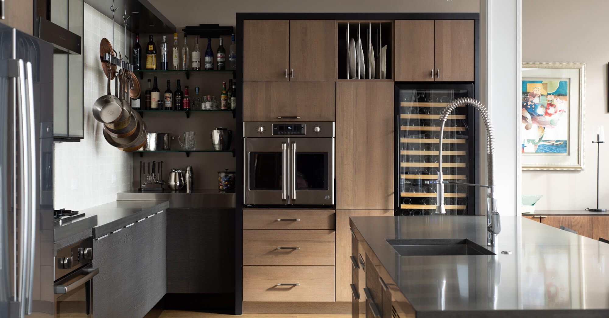 An industrial style kitchen design with two tone slab style cabinets.