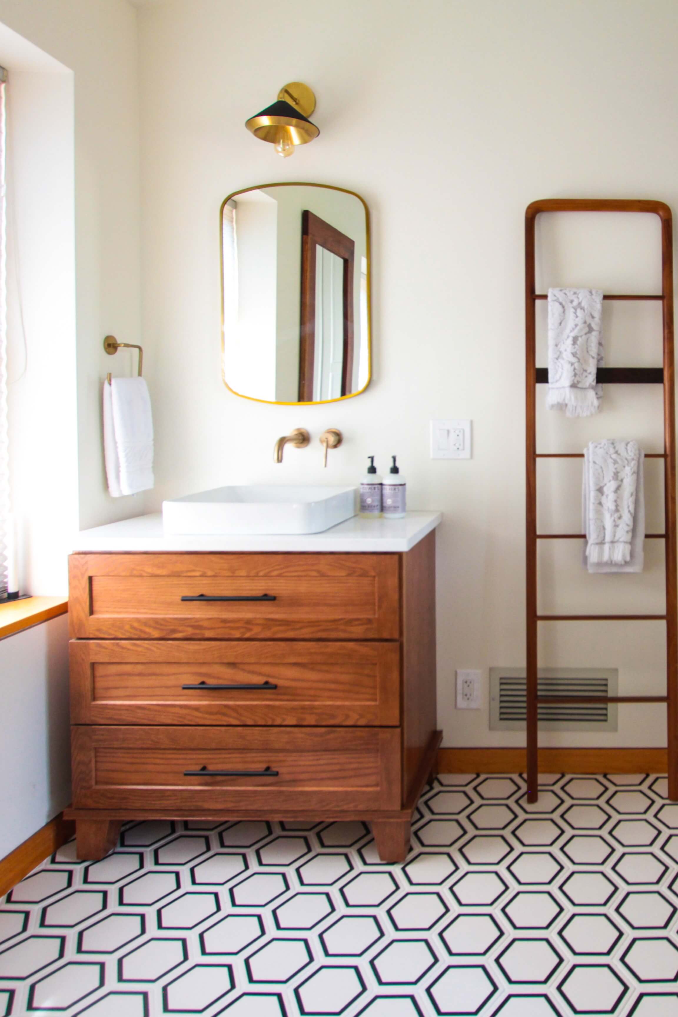 A rich stained bath vanity with a furniture style featuring vanity leg, bun feet that lift the cabinetry up from the floor.