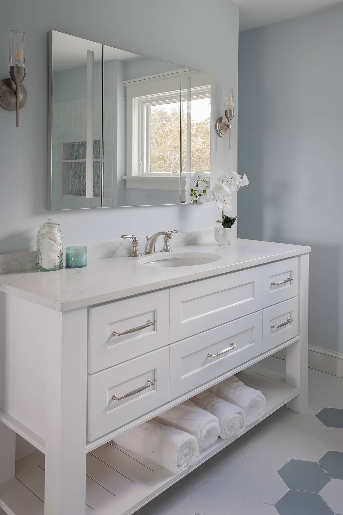 A bright white painted vanity with a furniture style featuring modern turned post legs.