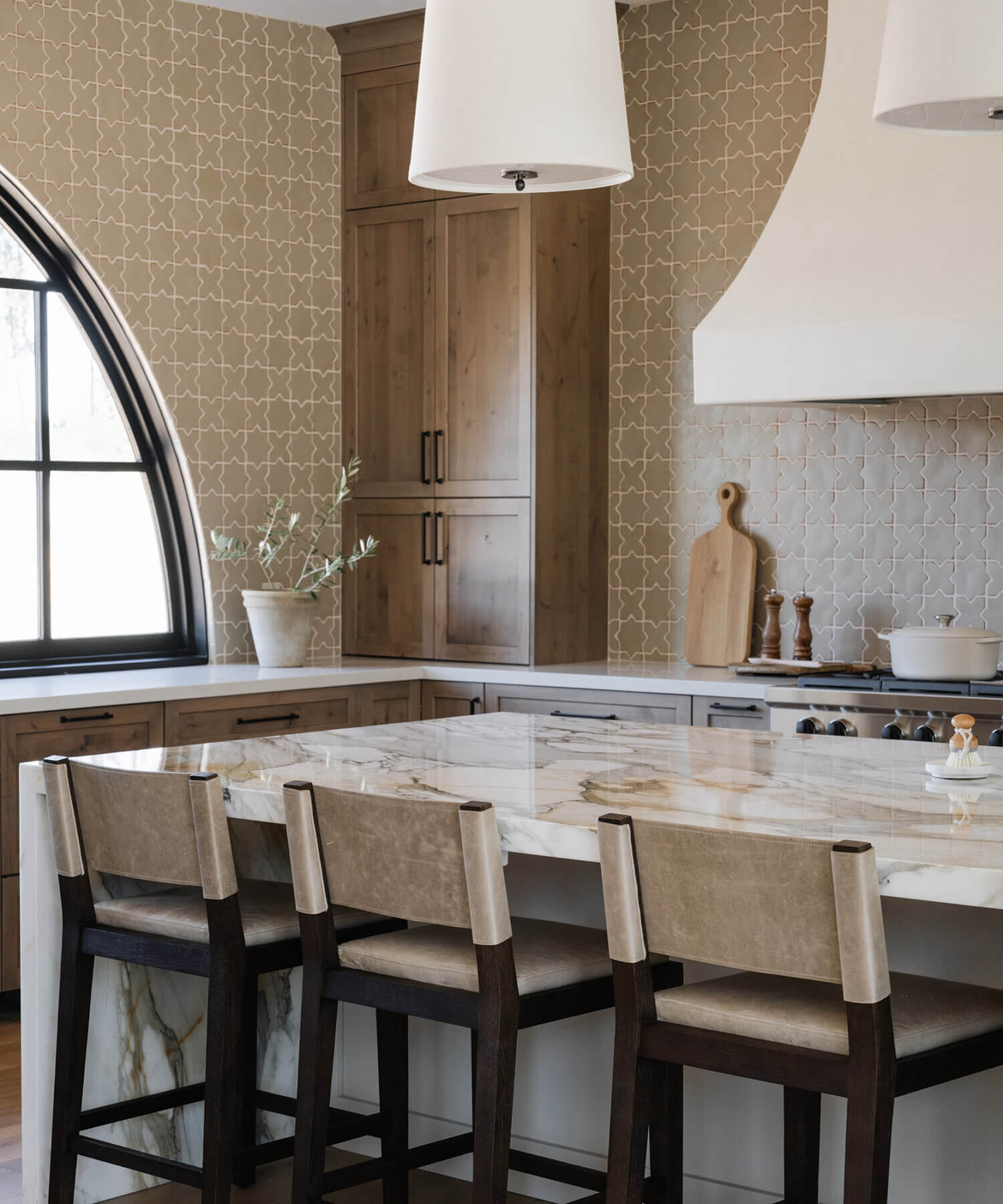 With an emphasis on comfort, heritage-inspired details, and lived-in textures, this family home is a Mediterranean oasis. This stunning Mediterranean inspired home features Dura Supreme’s Hudson shaker door style in a combination of the “Cashew” stain on Knotty Alder
