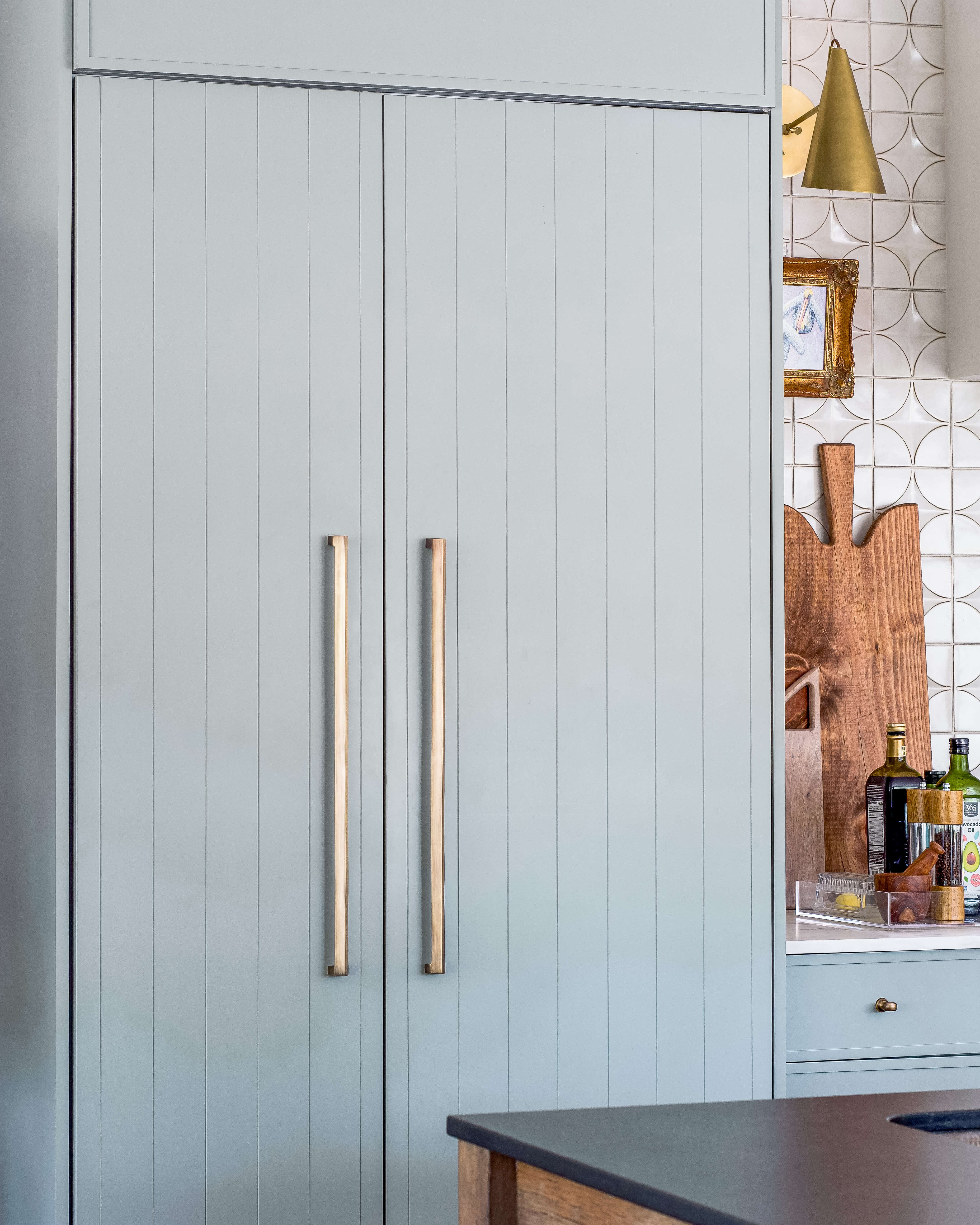 A slab cabinet door with shiplap details in a light blue color with bohemian style.