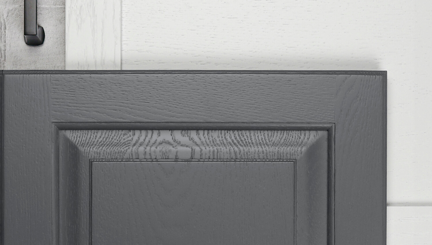A close up of two cabinet doors with white and gray painted wood finishes with a painted texture of wood grain.