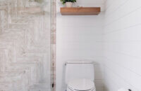 Two floating shelves above the toilet match the vanity.