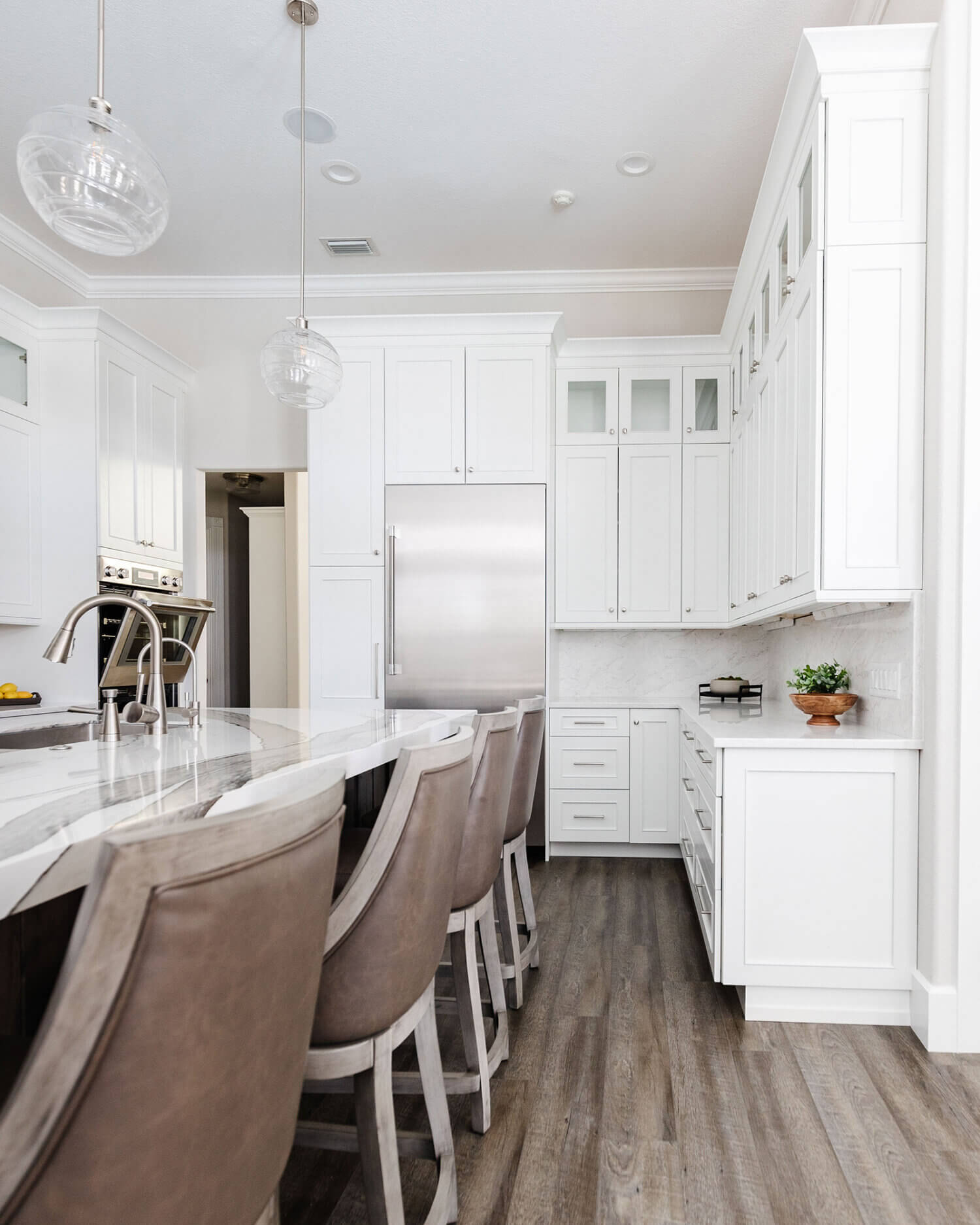 A classic kitchen design with white painted kitchen cabinetry and a large knotty alder kitchen island.