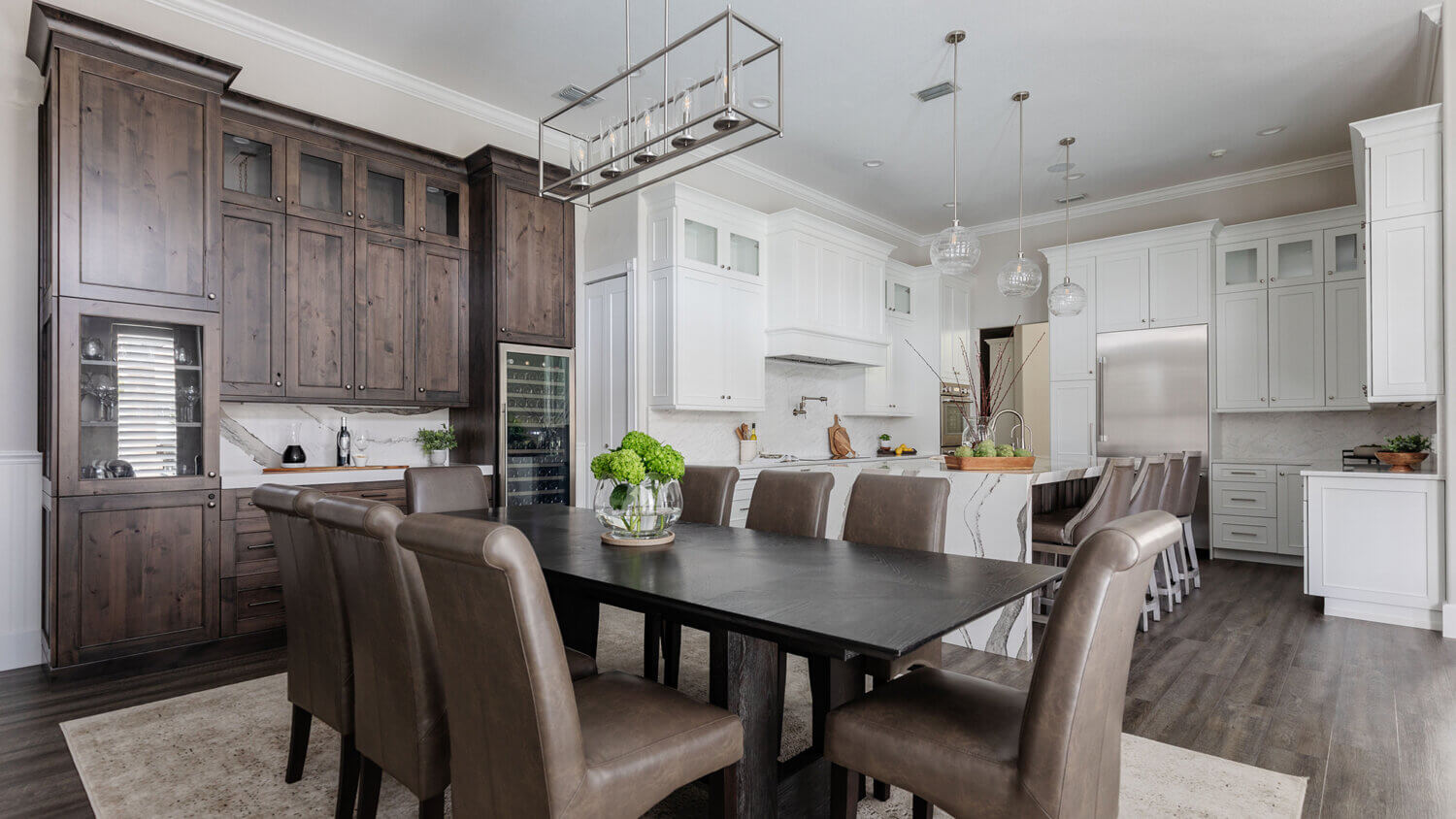 A view from the dining room showing the beverage center wall in knotty alder cabinets in the dining room contrasting the white painted cabinets in the kitchen.