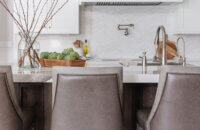 An elegant kitchen design with a combination of white painted cabinets and dark stained knotty alder cabinets.