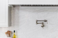 A built-in integrated wood hood with panels that match the cabinet door style.