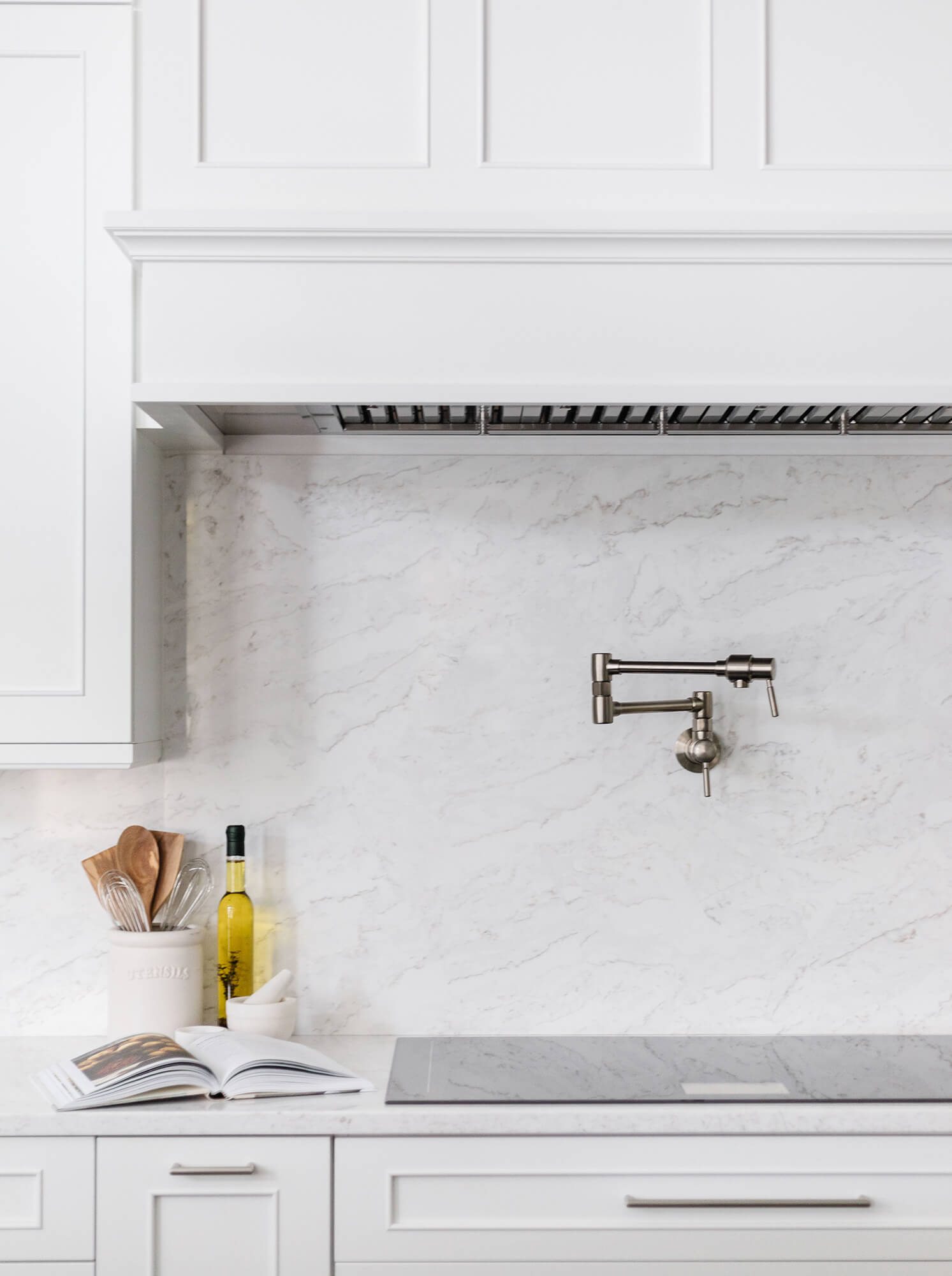 A built-in integrated wood hood with panels that match the cabinet door style.