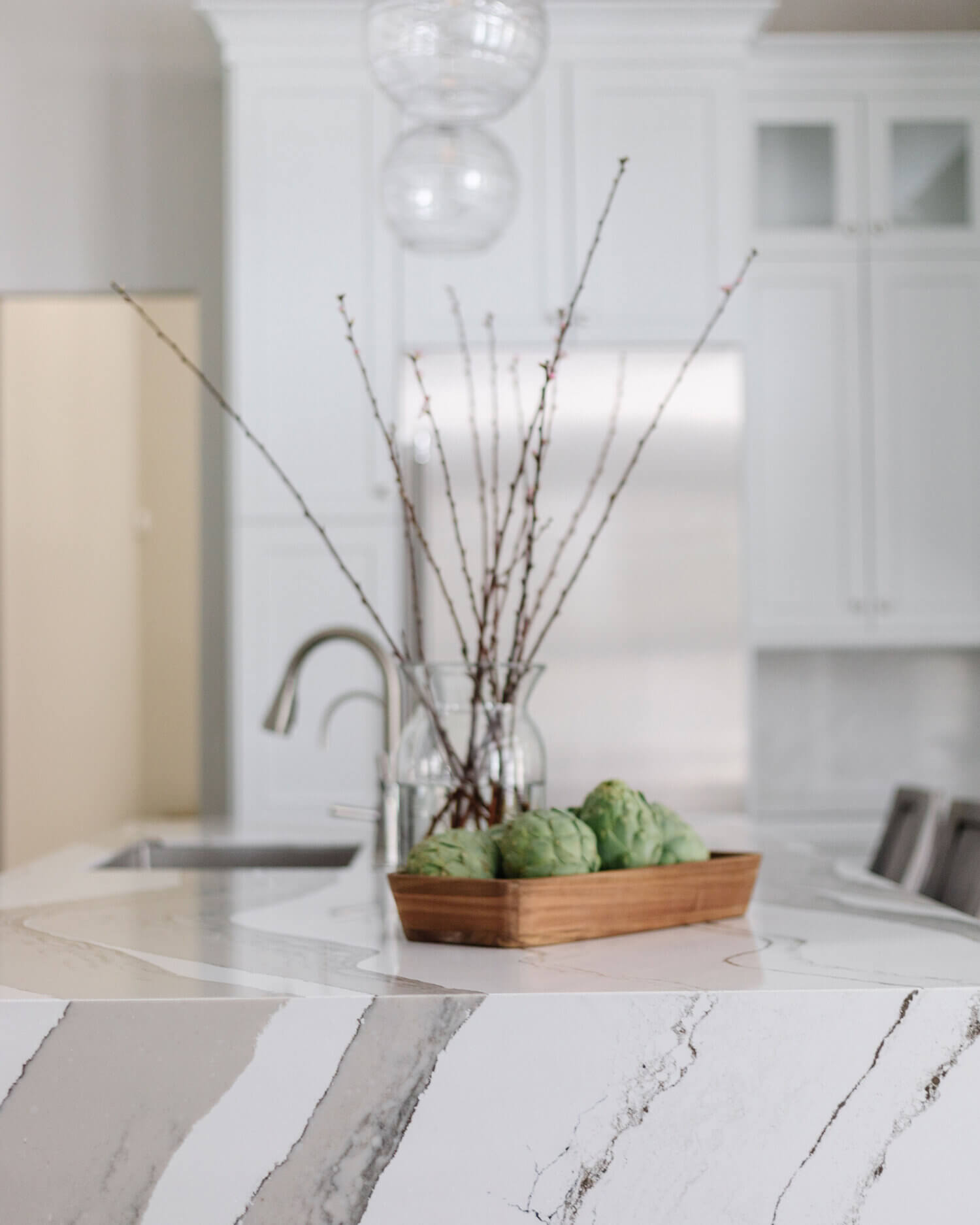 A closeup of the waterfall counter top on the kitchen island with Cambria quartz.