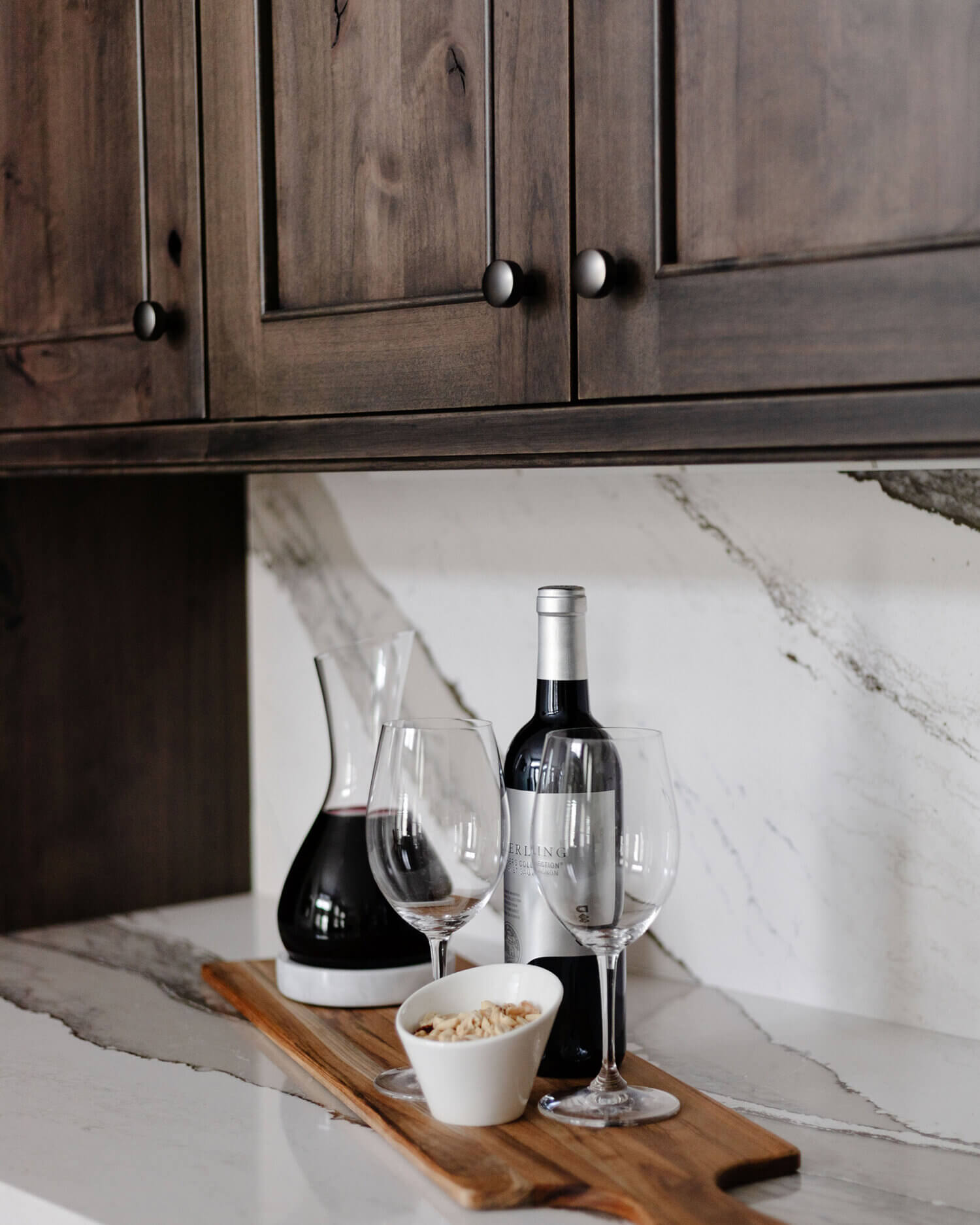 A close up of the knotty alder cabinets paired with the Cambria quartz countertop and backsplash.