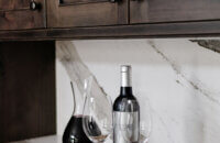 A close up of the knotty alder cabinets paired with the Cambria quartz countertop and backsplash.