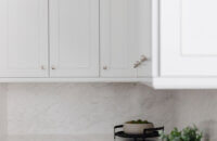 A elegant white painted cabinets with a luxurious cabinet door style.