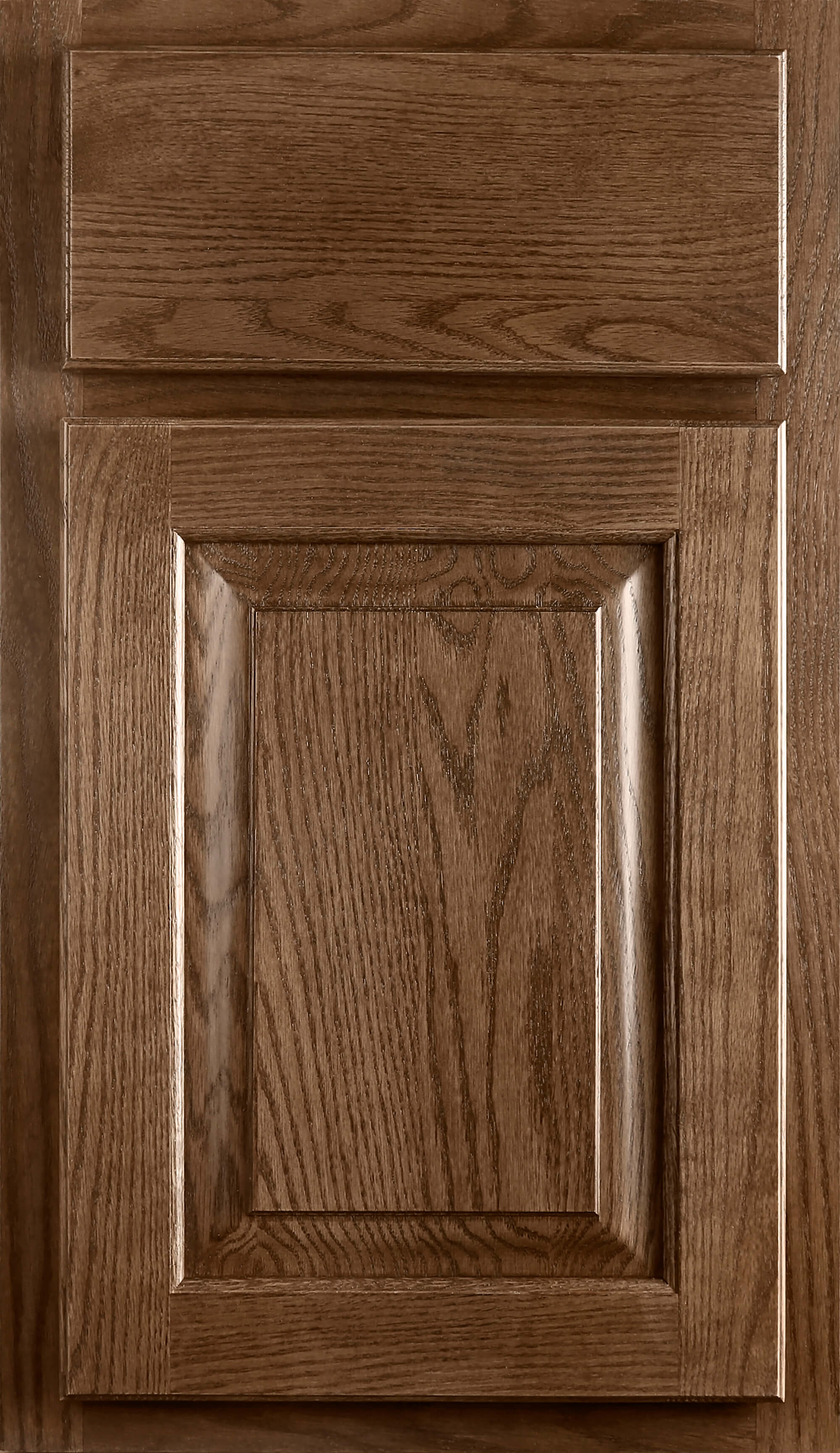 A standard overlay door style with a raised panel door and slab drawer front in a medium stain on Red Oak wood showing the beautiful plain-sawn grain pattern.