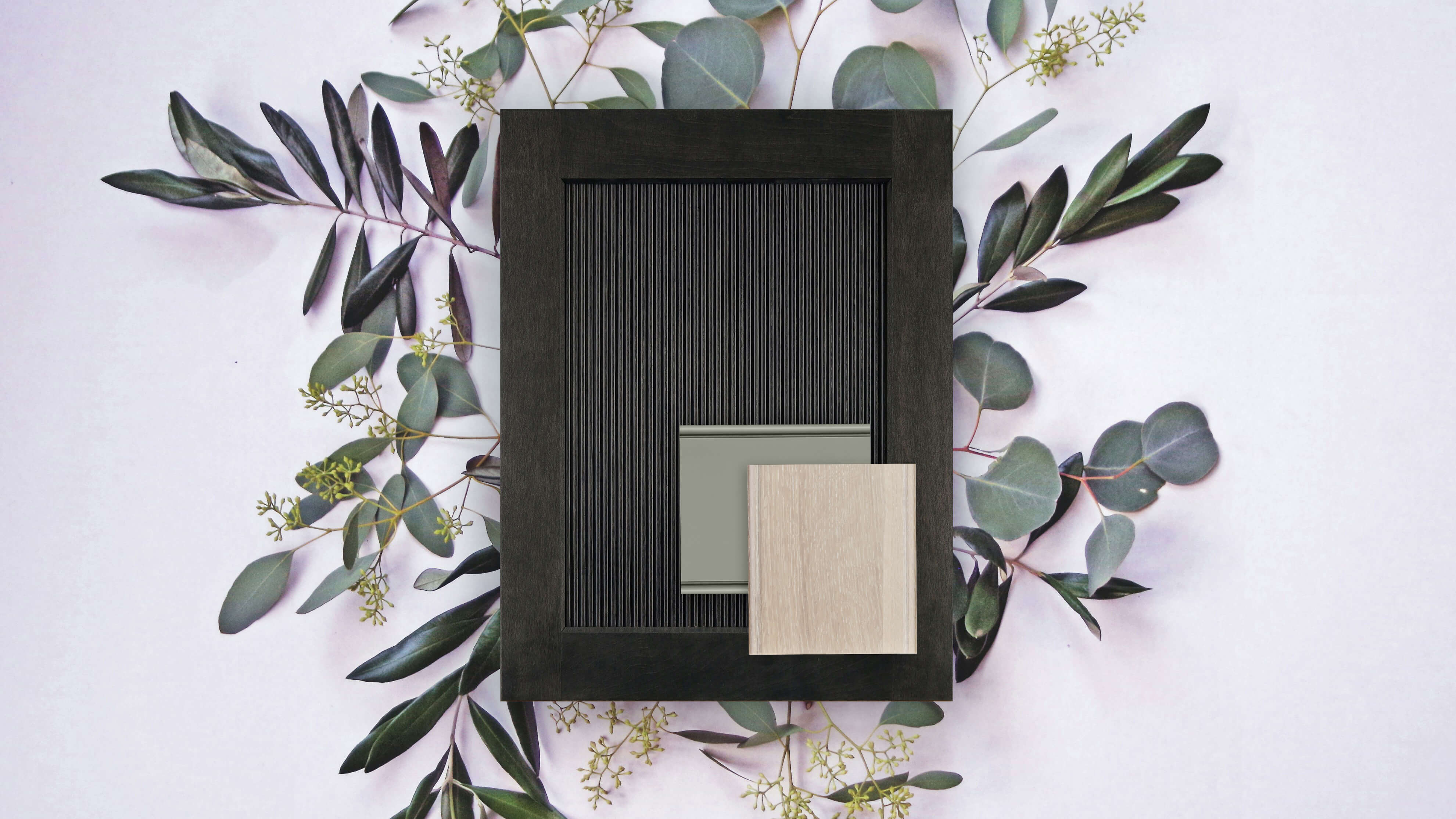A Biophilic style flat lay showing a reeded cabinet door with a dark stain, a light cerused finish and a sage green finish for selecting cabinetry for a kitchen remodel.